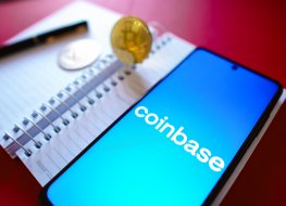 Coinbase logodisplayed on a smartphone screen beside Bitcoin cryptocurrencies