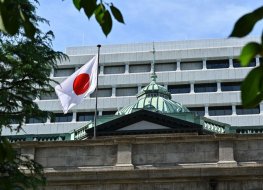 The Japanese national flag flutters in the wind on part of the Bank of Japan 