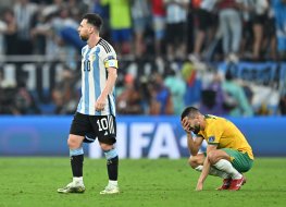 Lionel Messi (10) of Argentina celebrates their victory and a player of Australia gets upset after the FIFA World Cup Qatar 2022 Round of 16 match between Argentina and Australia at Ahmad Bin Ali Stadium in Al Rayyan, Qatar on 3 December, 2022