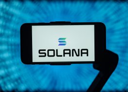 The Solana (SOL) logo is displayed on a smartphone
