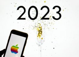A image of an Apple iPhone against a sign of 2023