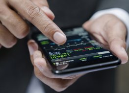businessman using a mobile phone to check stock market data