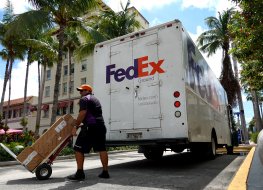 FedEx worker makes a delivery in Miami Beach, Florida