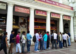 People stand in a queue outside a bank ATM in Connaught Place, New Delhi, India