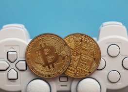 Representation of crypto gaming featuring crypto coins in front of a game controller