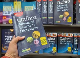 Someone holding an Oxford Dictionary 