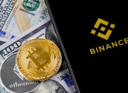 Binance logo, bitcoin, ether and US dollar on desk