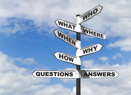Questions signposts The big 5 questions highlighted on a signpost with a blue sky and clouds behind