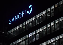 Sanofi sign lit up on building at night