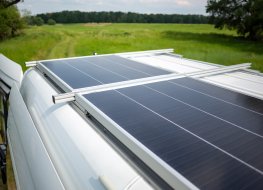 Solar van in a green field