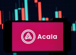 The Acala logo on a phone, in front of a price chart