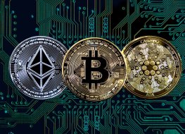 Bitcoin, ethereum (ether) and cardano cryptocurrency token coins against circuit board background