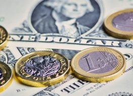 currency Pound and euro coins against US dollar bank notes: