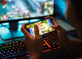 gaming industry A person playing games on a smartphone