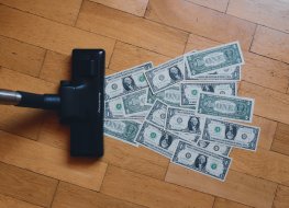 Dollar bills being vacuumed up