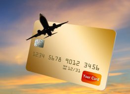Representation of a jet airliner flying out of a generic credit card