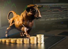 Coins in front of bull with data illustration