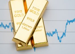 Gold ingots against a line chart