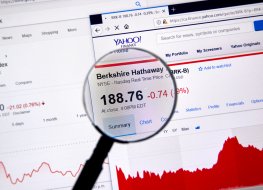 Berkshire Hathaway BRK-B ticker with shares price and charts under magnifying glass