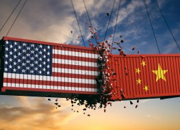 Two shipping containers daubed in the flags of the US and China smash into each other