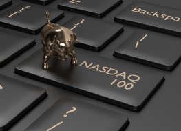 A key on a computer keyboard adapted to say NASDAQ 100, with a small gold bull charm sitting on it 
