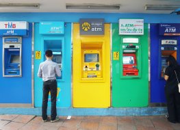 People withdraw cash from Thai ATMs
