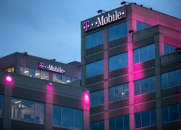 Bellevue, Washington / USA - January 3 2019: Tiered exterior of the T Mobile headquarters building at night, with exterior magenta lights, and space for text on the bottom