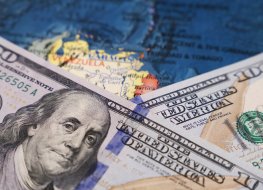 US dollars and map of Venezuela 