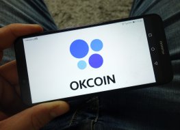 Okcoin logo on a smartphone 