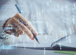 Financial forex graph displayed on hands taking notes background. Concept of research. Double exposure