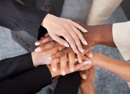 Great Resignation Businesspeople stacking hands over each other