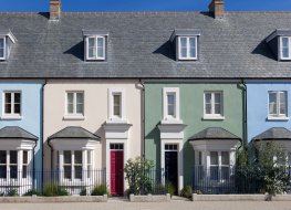 A terrace of houses painted in a variety of pastel shades