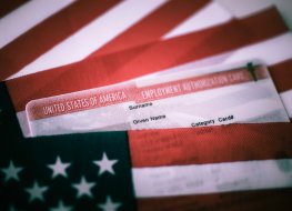 A picture of an Employment Authorisation card covered of USA Flag. Close up view. 