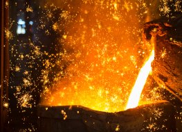Shower of sparks as molten metal is poured in steel foundry