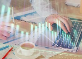 Chevron stock forecast: Will it fall lower? Forex graph with businessman working on computer in office on background. Concept of hardworking. Double exposure.