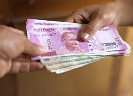 Small stack of Indian rupee notes changing hands
