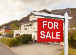 For Sale sign in front of home