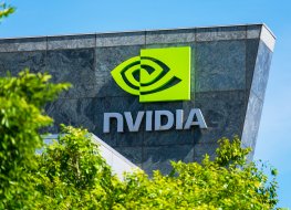 A photo of the outside of a NVIDIA building, showing the company's logo in green on the outside