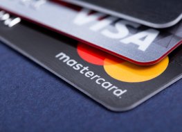 A photo of Visa (V) and MasterCard (MA) credit cards.