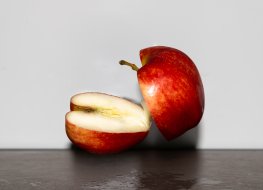 An apple divided into two halves.