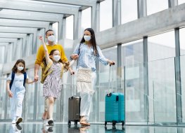 Family wearing masks at an airport