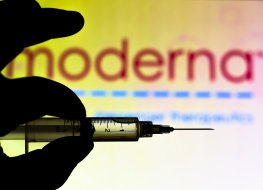 Medical syringe set against Moderna Therapeutics company logo 