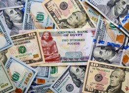 US dollar and Egyptian pound banknotes overlapped