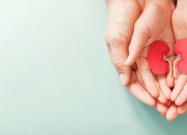 ProKidney Adult and child hands holding paper representing kidneys