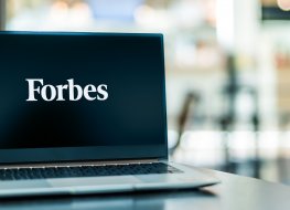 Laptop displaying the logo of Forbes Media