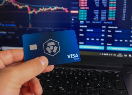 Man holding Crypto.com debit card in hand