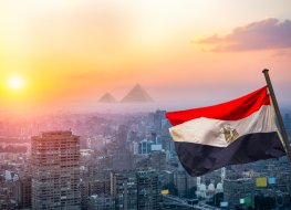 View of evening Cairo from above and egyptian flag