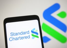  In this photo illustration Standard Chartered plc logo of a British multinational banking and financial services company is seen on a mobile phone screen.