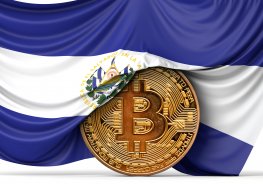 El Salvador flag draped over a bitcoin