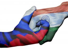 Diplomatic handshake between countries: flags of Russia and India overprinted the two hands